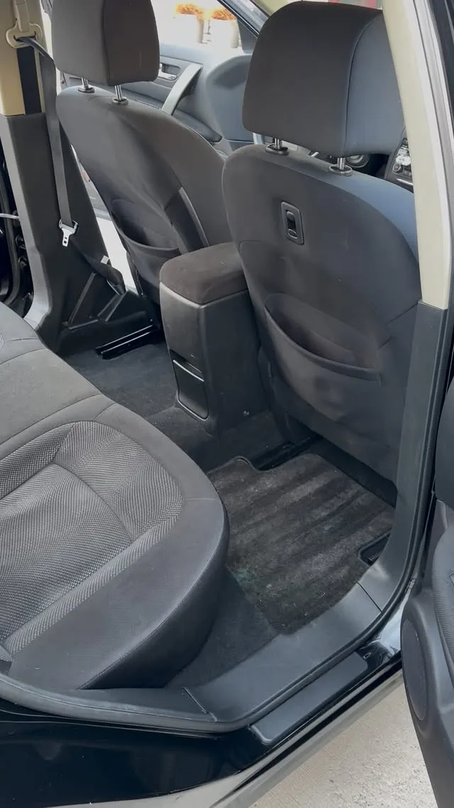 The same footwell after a PureFlex detail — carpet extracted, plastics restored
